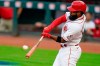 Cincinnati Reds' Brian Goodwin hits an RBI sacrifice fly during the first inning of the team's baseball game against the Pittsburgh Pirates in Cincinnati, Tuesday, Sept. 15, 2020. (AP Photo/Bryan Woolston)