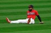 Cleveland Indians' Delino DeShields sits on the ground after committing an error during the ninth inning of Game 2 of the eam's American League wild-card baseball series against the New York Yankees, Thursday, Oct. 1, 2020, in Cleveland. The Yankees won 10-9. (AP Photo/David Dermer)
