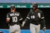 Chicago White Sox's Yoan Moncada (10) is congratulated by Luis Robert (88) after Moncada scored in the ninth inning in a baseball game against the Cleveland Indians, Wednesday, July 29, 2020, in Cleveland. (AP Photo/Tony Dejak)