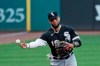 Chicago White Sox's Yoan Moncada throws out Cleveland Indians' Domingo Santana at first base in the first inning in the second baseball game of a doubleheader, Tuesday, July 28, 2020, in Cleveland. (AP Photo/Tony Dejak)