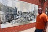 Freeman Culver stands in front of a mural listing the names of businesses destroyed during the Tulsa race massacre in Tulsa, Okla., Monday, June 15, 2020, on the other side of what's historically the city's white-black dividing line from where President Donald Trump will rally Saturday. (AP Photo/Sue Ogrocki)