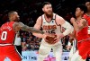 Phoenix Suns center Aron Baynes, center, drives to the basket between Portland Trail Blazers guards Damian Lillard, left, and Anfernee Simons, right, during the second half of an NBA basketball game in Portland, Ore., Tuesday, March 10, 2020. The Blazers won 121-105. (AP Photo/Steve Dykes)