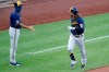 Milwaukee Brewers' Ben Gamel (16) rounds third past the outstretched hand of coach Ed Sedar after hitting a two-run home run off Pittsburgh Pirates starting pitcher Joe Musgrove during the third inning of a baseball game in Pittsburgh, Wednesday, July 29, 2020. (AP Photo/Gene J. Puskar)
