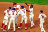 Philadelphia Phillies' Alec Bohm celebrates with teammates after hitting the game-winning two-run single off Boston Red Sox pitcher Matt Barnes during the seventh inning of the first baseball game in a doubleheader, Tuesday, Sept. 8, 2020, in Philadelphia. (AP Photo/Matt Slocum)