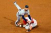 Atlanta Braves second baseman Johan Camargo, left, leaps over Philadelphia Phillies' J.T. Realmuto after forcing him out at second on a double play hit into by Jean Segura during the ninth inning of a baseball game, Sunday, Aug. 30, 2020, in Philadelphia. (AP Photo/Matt Slocum)