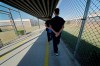 In a Thursday, Sept. 26, 2019 file photo, detainees walk with their hands clasped behind their backs along a line painted on a walkway inside the Winn Correctional Center in Winnfield, La. The Northwest Teritories says it has released a small number of prisoners over concerns about the possible spread of COVID-19 in territorial jails. THE CANADIAN PRESS/AP/Gerald Herbert, File