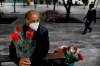 Wearing a mask to curb the spread of the new coronavirus, Martha Gonzalez Reyes, 76, sells roses outside Metro Hidalgo in central Mexico City, Monday, Aug. 10, 2020. After four months staying at home, Gonzalez returned to selling on August 1, but she says business hasn't fully rebounded. 