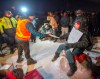 Police serve an injunction to protesters at a rail blockade in St-Lambert, south of Montreal, Que. on Thursday, February 20, 2020. The protesters are blocking the line in solidarity with the Wet'suwet'en hereditary chiefs opposed to the LNG pipeline in northern British Columbia. THE CANADIAN PRESS/Ryan Remiorz