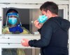 A man removes his face mask before being tested at a COVID-19 testing clinic Friday, May 1, 2020 in Montreal North. The area has been identified as one of the hardest hit with COVID-19 on the island. THE CANADIAN PRESS/Ryan Remiorz