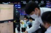 Currency traders watch monitors at the foreign exchange dealing room of the KEB Hana Bank headquarters in Seoul, South Korea, Wednesday, Nov. 4, 2020. U.S. futures rose and Asia markets posted gains as investors worldwide await the results from the U.S. presidential election. (AP Photo/Ahn Young-joon)