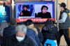 People watch a TV screen showing images of South Korean director Bong Joon Ho during a news program at the Seoul Railway Station in Seoul, South Korea, Monday, Feb. 10, 2020. In a milestone win that instantly expanded the Oscars' horizons, Bong's masterfully devious class satire 