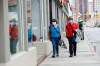 A couple wear masks while out for a walk in downtown Ottawa during the COVID-19 pandemic on Friday, May 1, 2020. THE CANADIAN PRESS/Sean Kilpatrick