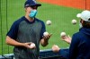 Tampa Bay Rays pitcher Blake Snell, left, juggles baseballs with a teammate during the seventh inning of Game 2 of an American League wild-card baseball series against the Toronto Blue Jays Wednesday, Sept. 30, 2020, in St. Petersburg, Fla. (AP Photo/Chris O'Meara)