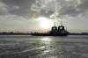 In this photo released by the Suez Canal Authority, tug boats approach the Panama-flagged, Japanese-owned Ever Given, which is lodged across the Suez Canal, Sunday, March 28, 2021. Two additional tugboats are speeding to canal to aid efforts to free the skyscraper-sized container ship wedged for days across the crucial waterway. That's even as major shippers increasingly divert their boats out of fear the vessel may take even longer to free. (Suez Canal Authority via AP)