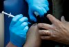 A nurse administers the Pfizer-BioNTech COVID-19 vaccine at Guy's Hospital in London, Tuesday, Dec. 8, 2020. U.K. health authorities rolled out the first doses of a widely tested and independently reviewed COVID-19 vaccine Tuesday, starting a global immunization program that is expected to gain momentum as more serums win approval. (AP Photo/Frank Augstein, Pool)