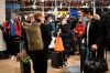 People wait on the concourse at Paddington Station in London, on the last Saturday shopping day before Christmas, after the announcement that London will move into Tier 4 COVID-19 restrictions from midnight, Saturday Dec. 19, 2020. (Stefan Rousseau/PA via AP)