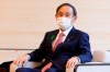 Japan's Prime Minister Yoshihide Suga wearing a face mask meets COP26 President Alok Sharma at the prime minister's official residence Monday, April 19, 2021, in Tokyo, Japan. (Rodrigo Reyes Marin/Pool Photo via AP)