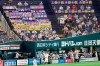 FILE - In this July 10, 2020, file photo, fans wearing face masks cheer as SoftBank Hawks' Nobuhiro Matsuda, center, celebrates after hitting a solo home run against Rakuten Golden Eagles in the second inning of a regular season baseball game in Fukuoka, southwestern Japan. Japan’s baseball and soccer leagues are ready to allow more fans into their games. The head of Japanese baseball and the soccer J-League on Tuesday, Sept. 8, 2020, said they are asking the government to allow a maximum of 20,000 fans, or up of 50% capacity — whichever number is smaller. (Kyodo News via AP, File)