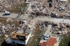 Emergency personnel work among destroyed homes Tuesday, March 3, 2020, near Cookeville, Tenn. Tornadoes ripped across Tennessee early Tuesday, shredding more than 140 buildings and burying people in piles of rubble and wrecked basements. At least 22 people were killed. (AP Photo/Mark Humphrey)