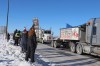 Bystanders watch a convoy of trucks pass through Brandon along the Trans Canada Highway, bound for Ottawa as part of a protest against pandemic restrictions and vaccine mandates, on Tuesday morning. (Kyle Darbyson/The Brandon Sun)