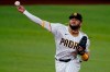 San Diego Padres' Fernando Tatis Jr. fields a ground out by Los Angeles Dodgers' Mookie Betts during the first inning in Game 3 of a baseball National League Division Series Thursday, Oct. 8, 2020, in Arlington, Texas. (AP Photo/Sue Ogrocki)