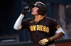 San Diego Padres' Manny Machado points upward while rounding the bases on his solo home run off Los Angeles Dodgers' Clayton Kershaw during the sixth inning in Game 2 of a baseball National League Division Series Wednesday, Oct. 7, 2020, in Arlington, Texas. (AP Photo/Sue Ogrocki)