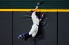 Los Angeles Dodgers' Cody Bellinger slams into the outfield wall and makes the catch as he robs San Diego Padres' Fernando Tatis Jr. of a home run on a deep drive during the seventh inning in Game 2 of a baseball National League Division Series Wednesday, Oct. 7, 2020, in Arlington, Texas. (AP Photo/Sue Ogrocki)