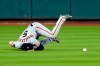 San Francisco Giants right fielder Mike Yastrzemski tumbles while trying to catch a two-run double by Houston Astros' Josh Reddick during the second inning of a baseball game Tuesday, Aug. 11, 2020, in Houston. (AP Photo/David J. Phillip)