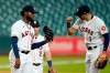 Houston Astros starting pitcher Cristian Javier, left, gets a fist bump from second baseman Carlos Correa (1) as he waits for manager Dusty Baker to pull him during the sixth inning of a baseball game against the Los Angeles Dodgers Wednesday, July 29, 2020, in Houston. (AP Photo/David J. Phillip)