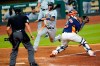 Seattle Mariners' Tim Lopes, center, avoids Houston Astros catcher Martin Maldonado to score a run during the eighth inning of a baseball game Sunday, July 26, 2020, in Houston. (AP Photo/David J. Phillip)