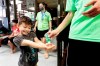 Bruce McCall, 5, smiles as he takes hand sanitizer during martial arts daycare summer camp at Legendary Blackbelt Academy in Richardson, Texas, Tuesday, May 19, 2020. As daycares and youth camps re-open in Texas, operators are following appropriate safety measure to insure kids stay safe from COVID-19. (AP Photo/LM Otero)