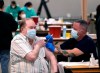 Howard Holland, 82, receives his first dose of the COVID-19 vaccine from Wes Vaughn at the Dallas County mass vaccination site at Fair Park Wednesday, Jan. 20, 2021, in Dallas. (AP Photo/LM Otero)