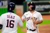 Houston Astros' Aledmys Diaz, left, congratulates Jose Altuve, right, after he scores the go-ahead run on the single by Kyle Tucker during the sixth inning of a baseball game against the Arizona Diamondbacks Saturday, Sept. 19, 2020, in Houston. (AP Photo/Michael Wyke)