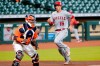 Los Angeles Angels' Jason Castro (16) scores as Houston Astros catcher Martin Maldonado, left, waits for the ball during the fifth inning of the first game of a doubleheader baseball game Tuesday, Aug. 25, 2020, in Houston. (AP Photo/Michael Wyke)