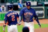 Houston Astros' Alex Bregman, left, and George Springer, right, celebrate Springer's inside the park home run during the sixth inning of a baseball game against the Arizona Diamondbacks Sunday, Sept. 20, 2020, in Houston. (AP Photo/Michael Wyke)
