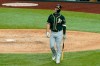 Oakland Athletics' Mark Canha walks back to the dugout after popping out to Texas Rangers catcher Jose Trevino in the sixth inning of a baseball game in Arlington, Texas, Monday, Aug. 24, 2020. (AP Photo/Tony Gutierrez)