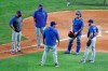 Texas Rangers manager Chris Woodward, left, bullpen coach Doug Mathis, second from left, pitching coach Julio Rangel, center front, catcher Blake Swihart, second from right, and pitcher Cody Allen, right, talk after Allen threw in a baseball practice at Globe Life Field in Arlington, Texas, Friday, July 3, 2020. (AP Photo/Tony Gutierrez)