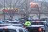 An off-duty police officer directs traffic outside of Costco along St James Street in December during the Christmas shopping rush. (Mike Sudoma / Winnipeg Free Press files)