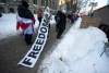 CP
A person walks with a banner with the word 