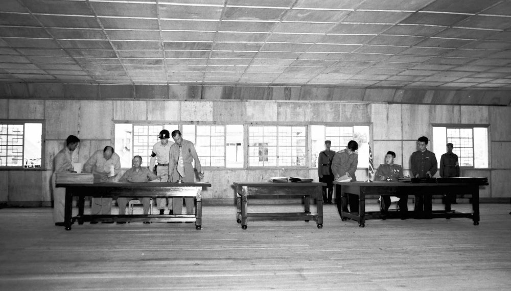 The Associated Press files
In this July 26, 1953, file photo, Gen. William K. Harrison, Jr., seated at left, and North Korean Gen. Nam Il, seated at right, sign armistice documents in Armistice Hall in Panmunjom, a no-man's-land between the Koreas.
