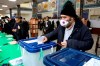 A voter casts his ballot in the parliamentary elections in a polling station in Tehran, Iran, Friday, Feb. 21, 2020. Iranians began voting for a new parliament Friday, with turnout seen as a key measure of support for Iran's leadership as sanctions weigh on the economy and isolate the country diplomatically. (AP Photo/Vahid Salemi)