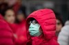 A woman wears a mask over her mouth and nose while attending the Chinese New Year Parade, in Vancouver, on Sunday January 26, 2020. THE CANADIAN PRESS/Darryl Dyck