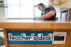 A custodian cleans a teacher's desk in a classroom at a school in Des Moines, Iowa. Last week, Manitoba's top doctor said the province would look at practices in other jurisdictions before taking further steps.  Some divisions are ordering masks now in case they are mandated. (Charlie Neibergall / The Associated Press files)