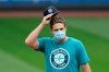 Seattle Mariners pitcher Kendall Graveman pulls on his cap at a 