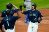 Seattle Mariners' Austin Nola (23) is greeted at home on his three-run home run by Kyle Lewis (1) and Kyle Seager during the third inning of a baseball game against the Los Angeles Dodgers on Wednesday, Aug. 19, 2020, in Seattle. (AP Photo/Elaine Thompson)