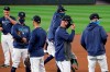 Seattle Mariners players gather to begin a 
