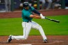 Seattle Mariners' Evan White doubles in a pair of runs against the Texas Rangers in the fourth inning of a baseball game Friday, Sept. 4, 2020, in Seattle. (AP Photo/Elaine Thompson)