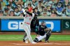 Los Angeles Angels' Shohei Ohtani (17) watches his solo home run as Seattle Mariners catcher Joe Hudson, right, looks on during the second inning of a baseball game Thursday, Aug. 6, 2020, in Seattle. (AP Photo/Ted S. Warren)