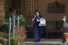 A worker at the Life Care Center in Kirkland, Wash., near Seattle, wears a mask as she leaves the building, Monday, March 2, 2020. Several of the people who have died in Washington state from the COVID-19 coronavirus were tied to the long-term care facility, where dozens of residents were sick. (AP Photo/Ted S. Warren)