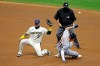 Milwaukee Brewers' Orlando Arcia (3) is unable to control a throw as Detroit Tigers' JaCoby Jones (21) steals second base during the fourth inning of a baseball game Tuesday, Sept. 1, 2020, in Milwaukee. Jones advanced to third base on the play. (AP Photo/Aaron Gash)
